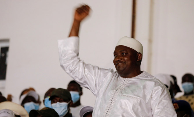 Adama Barrow raises his hand in a victory display