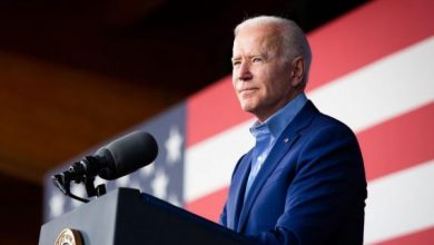 President Biden in a blue suit, gives an address