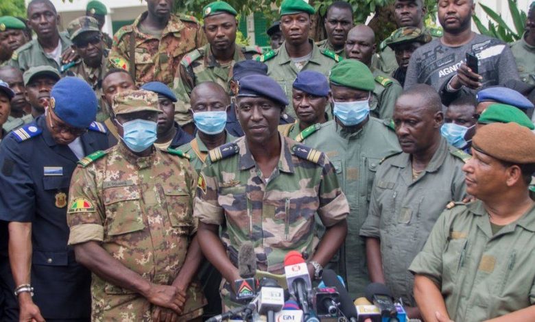 An array of Malian army officers addressing the press