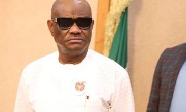 Governor Wike in a white attire and adorns a pair of sunglasses