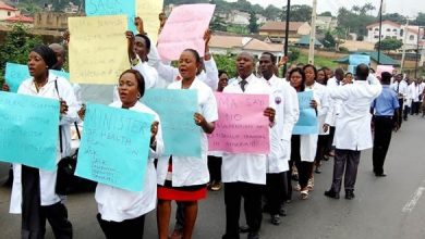 Medical practitioners carrying placards