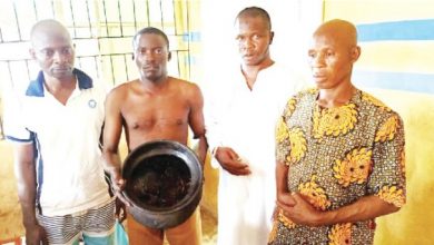 Four suspected ritualists hold a calabash